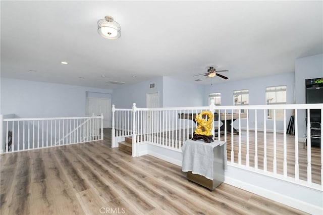 unfurnished room featuring baseboards, a ceiling fan, and wood finished floors