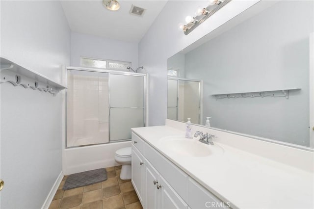 bathroom featuring visible vents, vanity, baseboards, toilet, and enclosed tub / shower combo