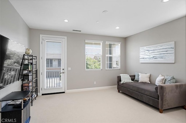 carpeted living area with visible vents, recessed lighting, and baseboards