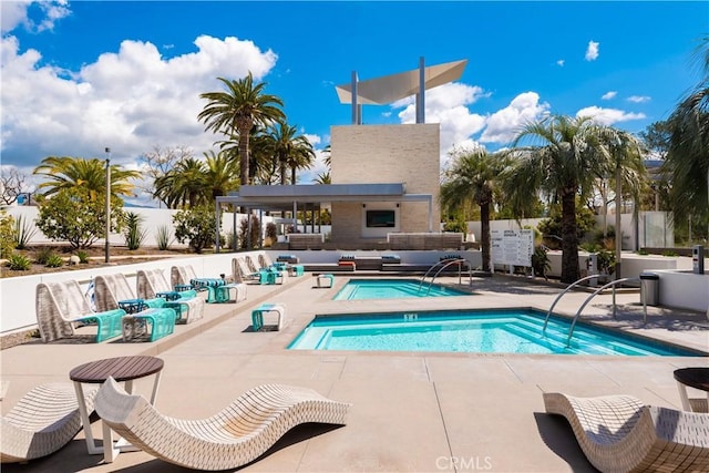 view of pool with a swimming pool, a patio area, an outdoor hangout area, and a community hot tub