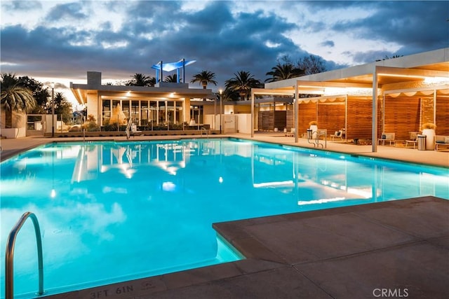 community pool with fence and a patio area