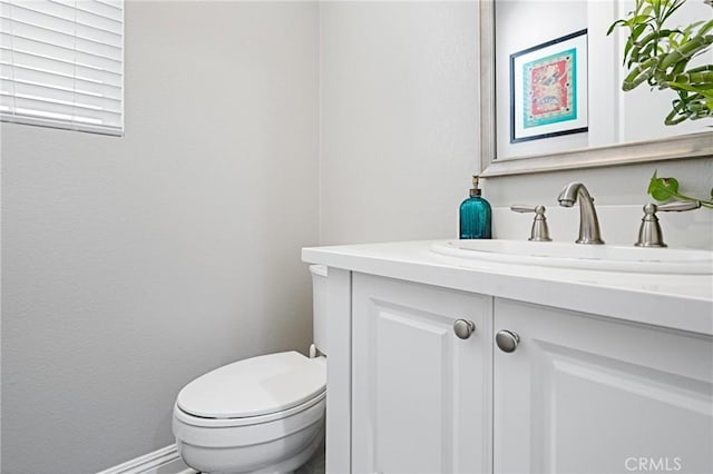 bathroom with toilet and vanity