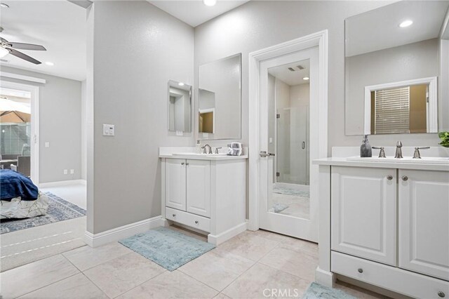 bathroom featuring a ceiling fan, a stall shower, two vanities, a sink, and recessed lighting