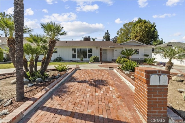 ranch-style home with a chimney