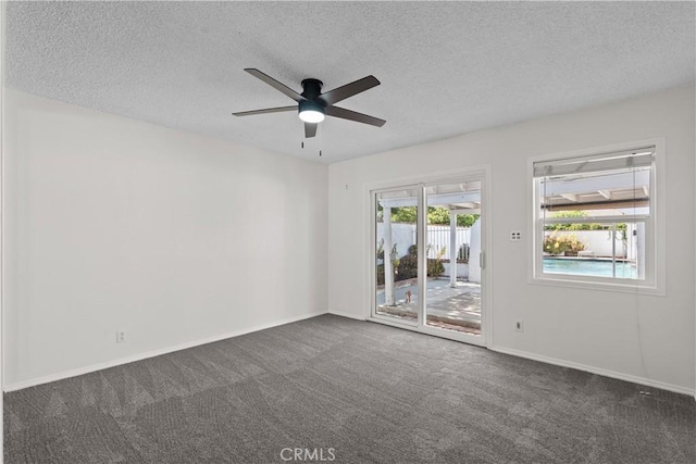unfurnished room with carpet floors, a textured ceiling, ceiling fan, and baseboards