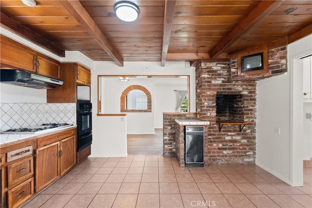 kitchen with oven, white gas cooktop, under cabinet range hood, wooden ceiling, and a warming drawer