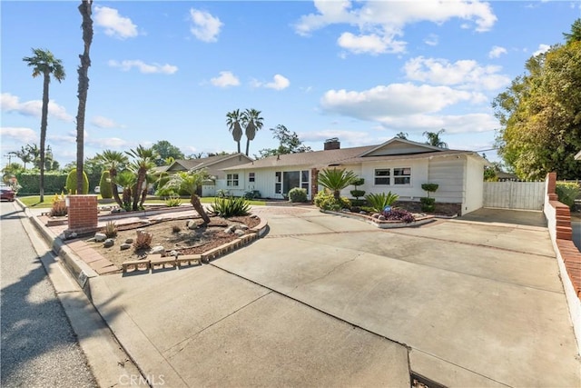 view of front of home featuring fence and driveway