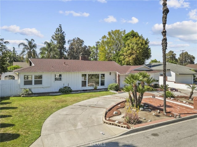 single story home with fence, roof with shingles, a front lawn, a chimney, and driveway