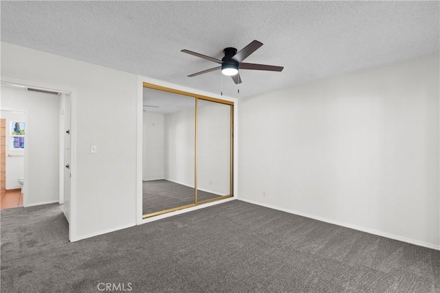 unfurnished bedroom with carpet floors, visible vents, a closet, ceiling fan, and a textured ceiling