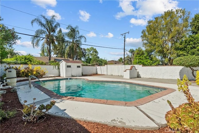 view of swimming pool featuring a fenced backyard, a storage unit, an outbuilding, and a patio area