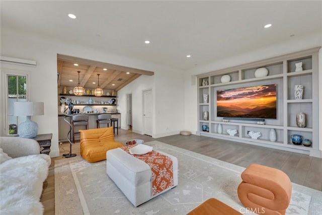 living room featuring baseboards, recessed lighting, and wood finished floors