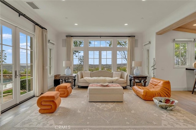 living area featuring recessed lighting, french doors, visible vents, and wood finished floors