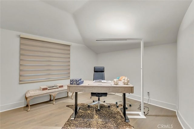 home office featuring baseboards, wood finished floors, and lofted ceiling