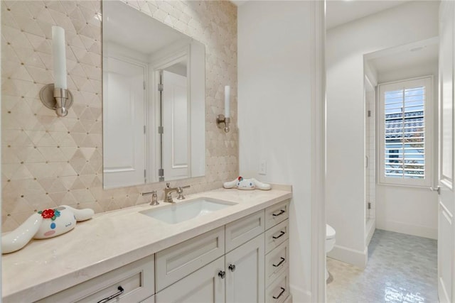 full bath featuring baseboards, tile patterned floors, vanity, and toilet