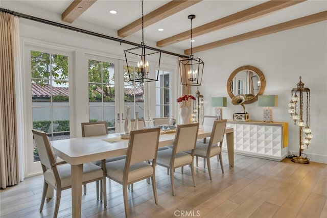 dining space with light wood-style floors, baseboards, beam ceiling, and a chandelier