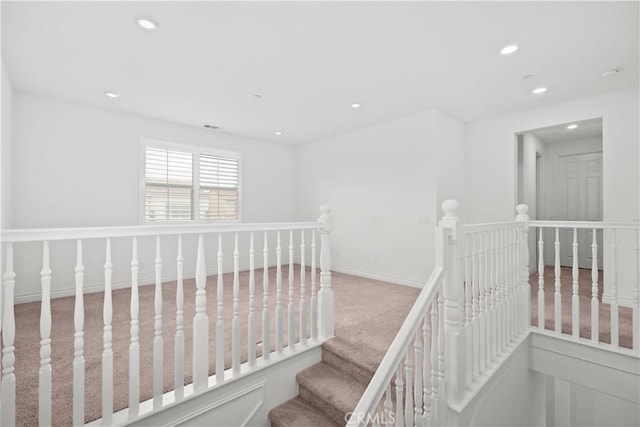 staircase with baseboards, carpet, and recessed lighting