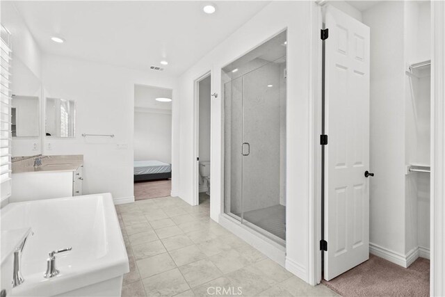 107 Frontier, Irvine, CA 92620 - ensuite bathroom featuring a stall shower, recessed lighting, a bath, vanity, and baseboards