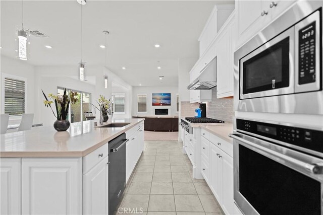 107 Frontier, Irvine, CA 92620 - kitchen with stainless steel appliances, open floor plan, backsplash, recessed lighting, and light countertops