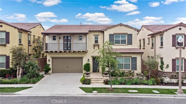 107 Frontier, Irvine, CA 92620 - view of front facade featuring a balcony, stucco siding, driveway, and a garage