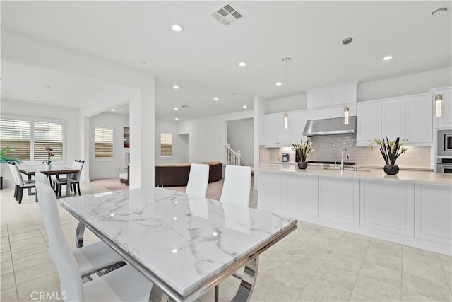 dining room with recessed lighting, visible vents, and stairway