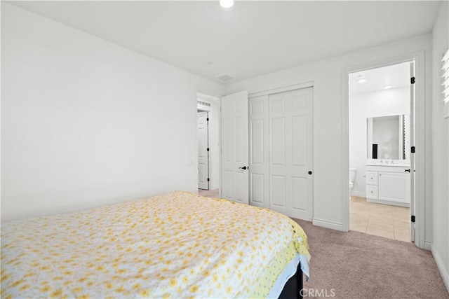 107 Frontier, Irvine, CA 92620 - bedroom featuring light colored carpet, a closet, recessed lighting, ensuite bath, and baseboards