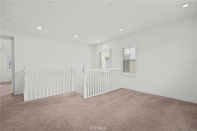 carpeted empty room featuring baseboards and recessed lighting
