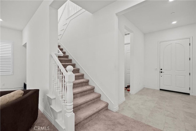 foyer featuring stairway, baseboards, and recessed lighting