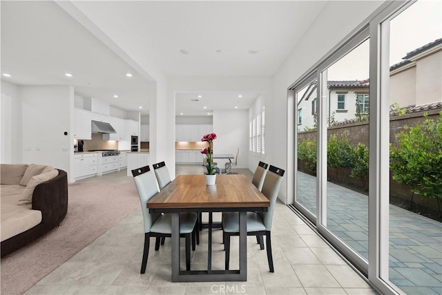 dining area with recessed lighting and light tile patterned floors