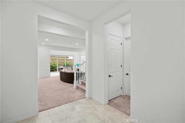 hall with recessed lighting, baseboards, stairs, and light carpet