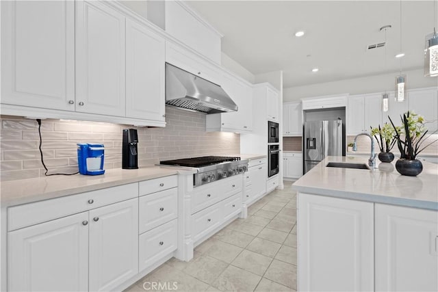 kitchen featuring a sink, decorative backsplash, under cabinet range hood, and stainless steel appliances