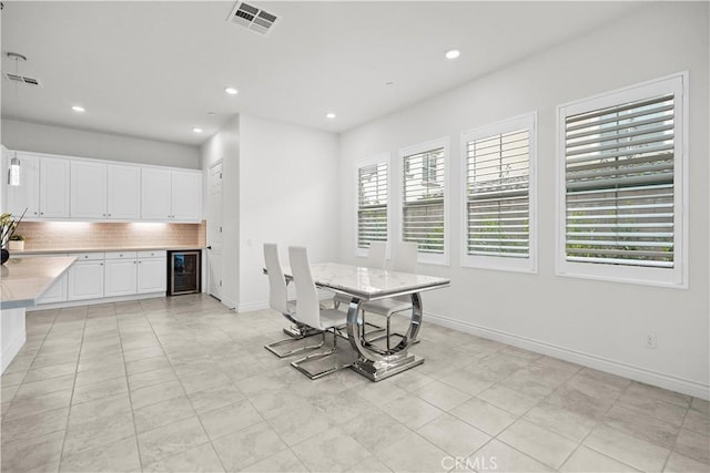 107 Frontier, Irvine, CA 92620 - dining room featuring beverage cooler, recessed lighting, baseboards, light tile patterned flooring, and a dry bar