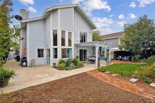 rear view of property with a pergola, fence, a chimney, and a patio