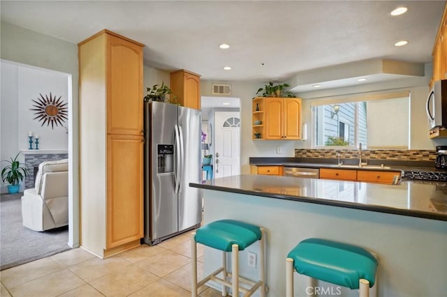 kitchen featuring open shelves, stainless steel appliances, a peninsula, light tile patterned floors, and visible vents