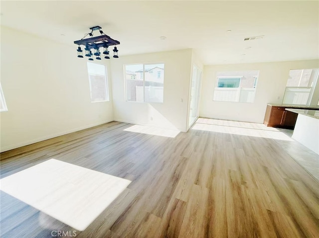 interior space featuring baseboards and light wood-style floors