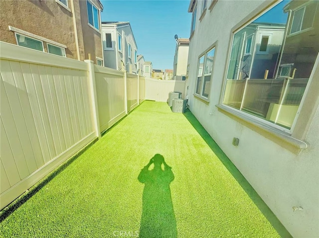 view of yard with fence and a residential view
