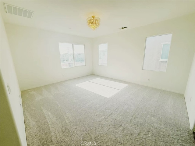 carpeted empty room with visible vents