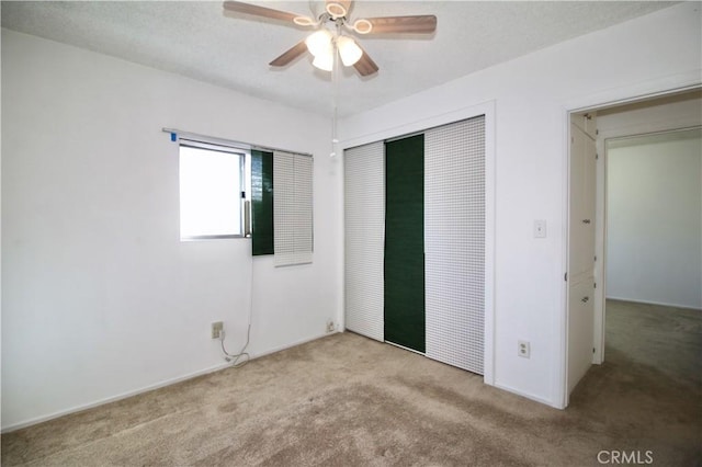 unfurnished bedroom featuring carpet floors, a ceiling fan, and a closet