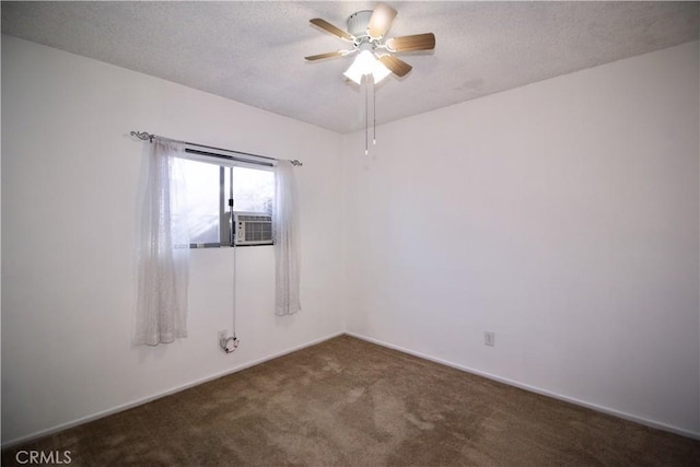 empty room with carpet floors, a ceiling fan, and a textured ceiling