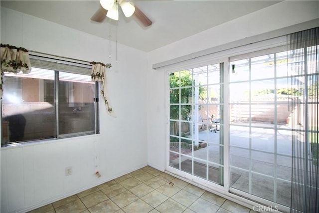 spare room featuring ceiling fan and light tile patterned flooring