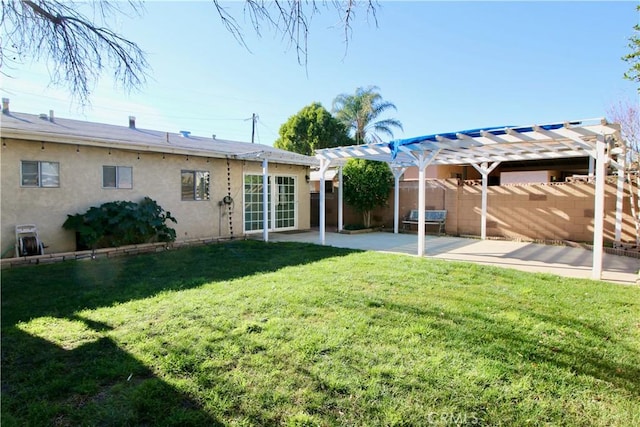 back of house with a pergola, stucco siding, a patio, a yard, and fence private yard