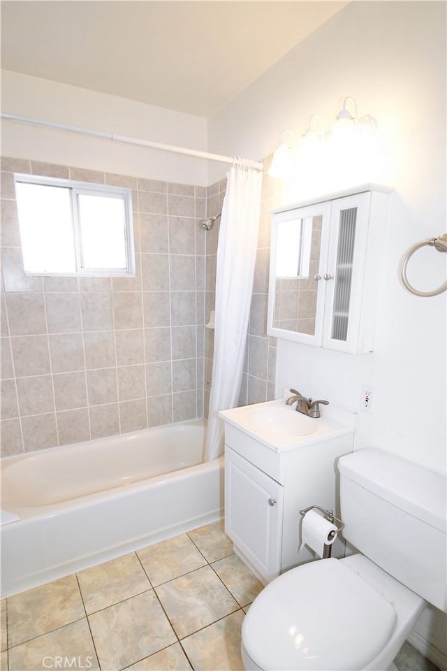 bathroom featuring vanity, tile patterned flooring, shower / bath combo with shower curtain, and toilet