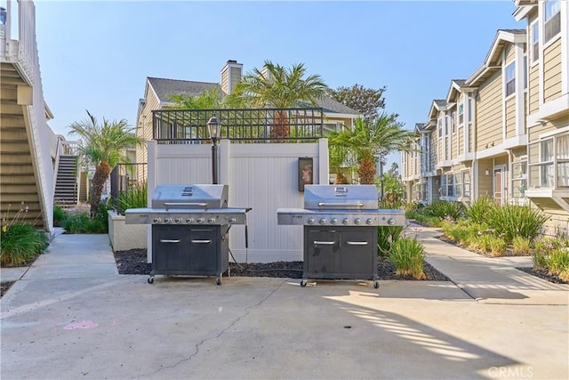 view of patio / terrace with a residential view and grilling area