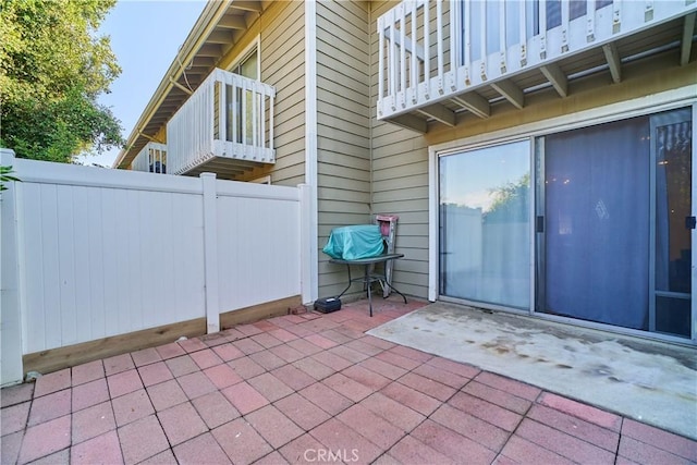 view of patio / terrace with fence and a balcony