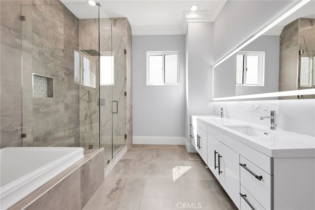 full bathroom featuring a sink, a marble finish shower, baseboards, ornamental molding, and a garden tub