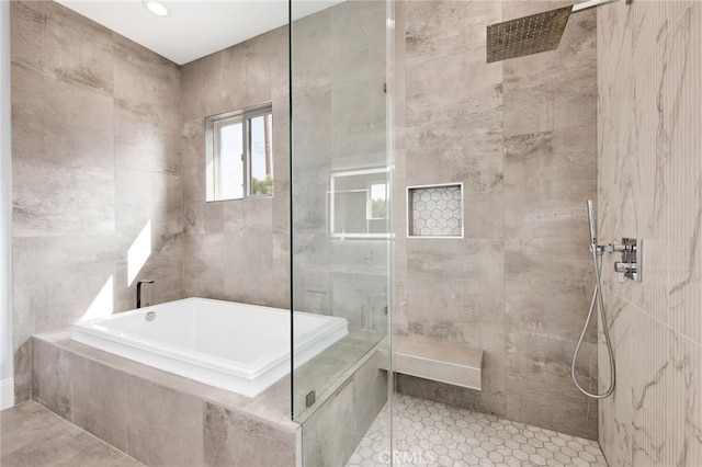 full bath featuring a garden tub and a tile shower