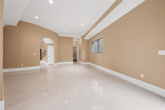 unfurnished room with recessed lighting, arched walkways, marble finish floor, and baseboards