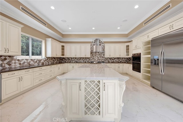 kitchen featuring visible vents, appliances with stainless steel finishes, a center island, marble finish floor, and wall chimney exhaust hood