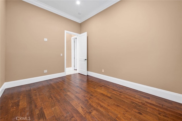 empty room featuring crown molding, baseboards, and dark wood-style floors