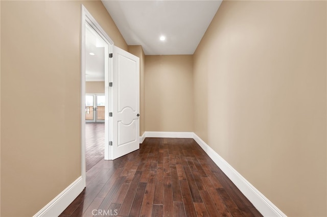 hallway featuring recessed lighting, baseboards, and dark wood finished floors