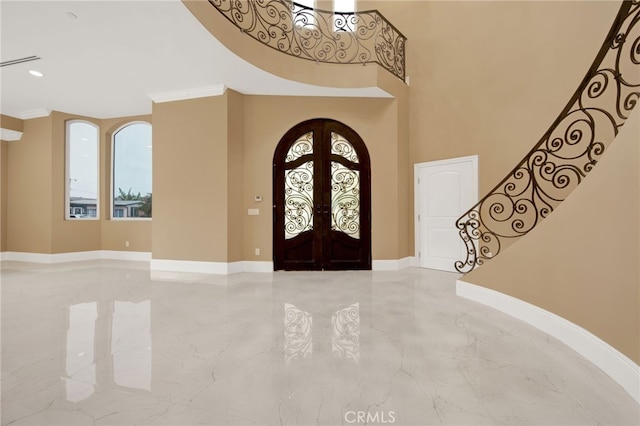 foyer featuring french doors, crown molding, stairway, baseboards, and marble finish floor